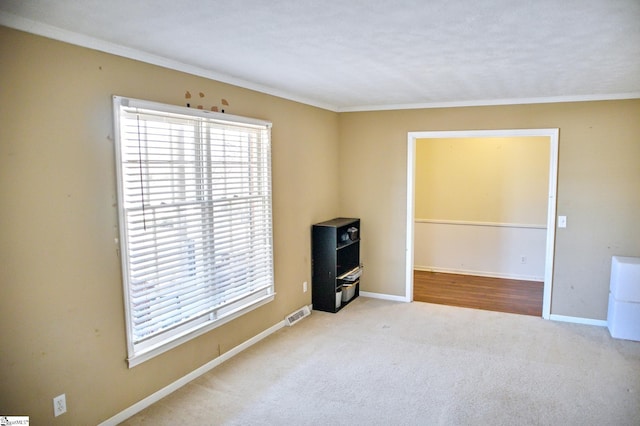 unfurnished room featuring carpet flooring, plenty of natural light, visible vents, and baseboards