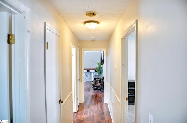 corridor featuring dark wood-type flooring