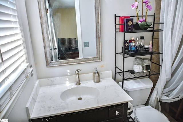 bathroom with vanity and toilet