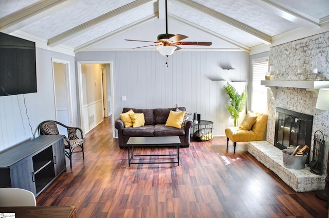 living room with lofted ceiling with beams, ceiling fan, a fireplace, and wood finished floors