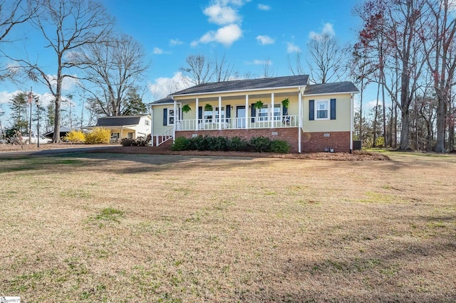 ranch-style home featuring a porch and a front lawn