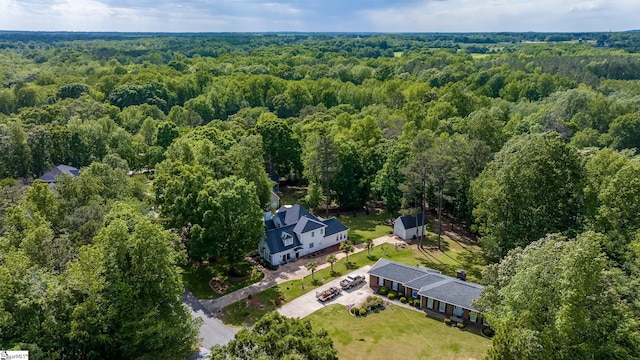 bird's eye view featuring a wooded view