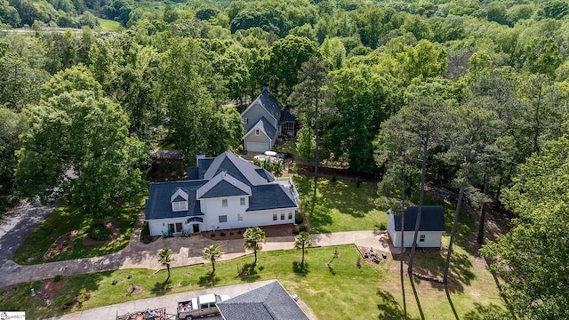 birds eye view of property with a forest view