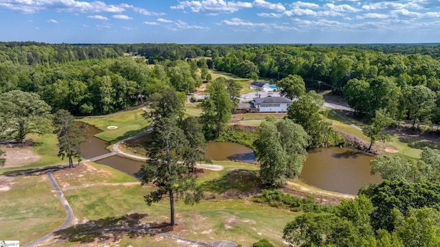 birds eye view of property featuring a forest view and a water view