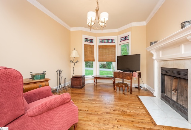 living area with baseboards, ornamental molding, wood finished floors, and a high end fireplace