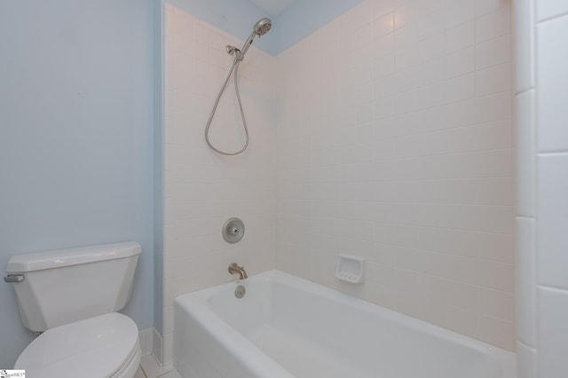 bathroom featuring shower / tub combination and toilet