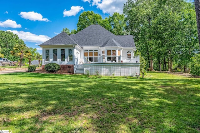 back of house with crawl space, a shingled roof, a lawn, and a wooden deck