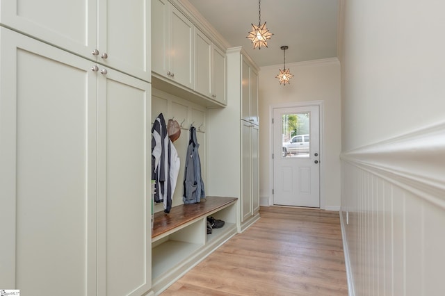 mudroom featuring ornamental molding and light wood-style flooring