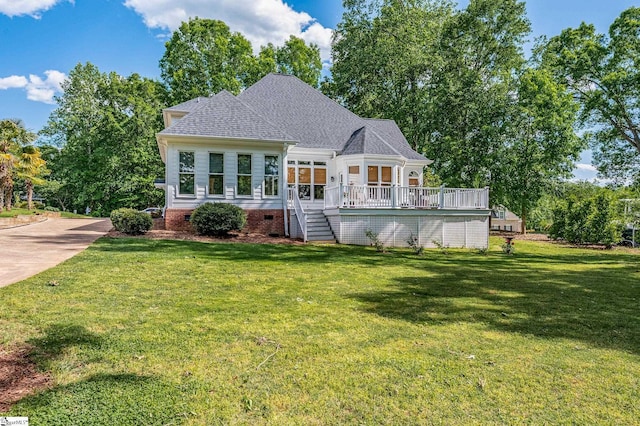 view of front of property with crawl space, a wooden deck, a shingled roof, and a front yard