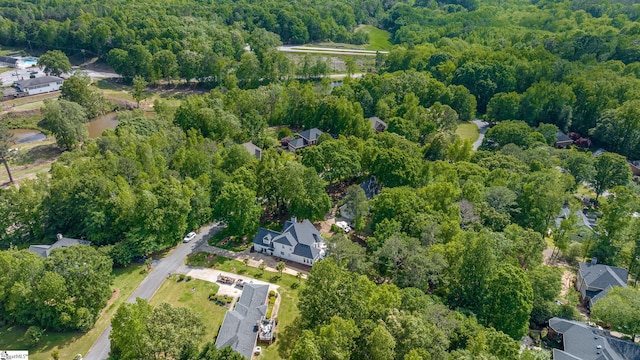 birds eye view of property featuring a wooded view