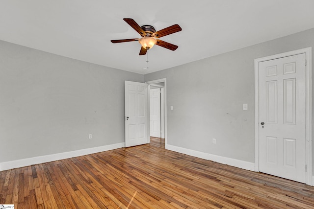 unfurnished room with a ceiling fan, baseboards, and light wood finished floors