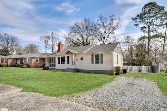 ranch-style house with fence, driveway, crawl space, a front lawn, and a chimney