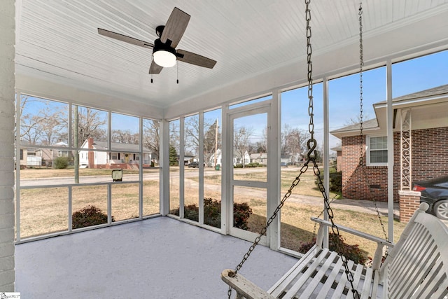 unfurnished sunroom with a ceiling fan