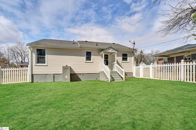 back of property featuring entry steps, a yard, crawl space, and a fenced backyard