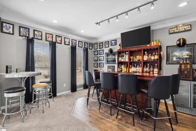 103 Hornbuckle Dr, Easley, SC 29642 - bar featuring recessed lighting, ornamental molding, a bar, beverage cooler, and baseboards