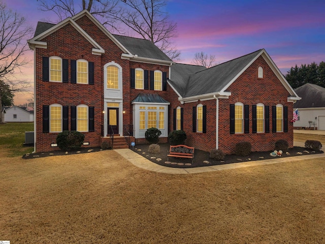 103 Hornbuckle Dr, Easley, SC 29642 - view of front of house with central AC unit, brick siding, a shingled roof, crawl space, and a lawn