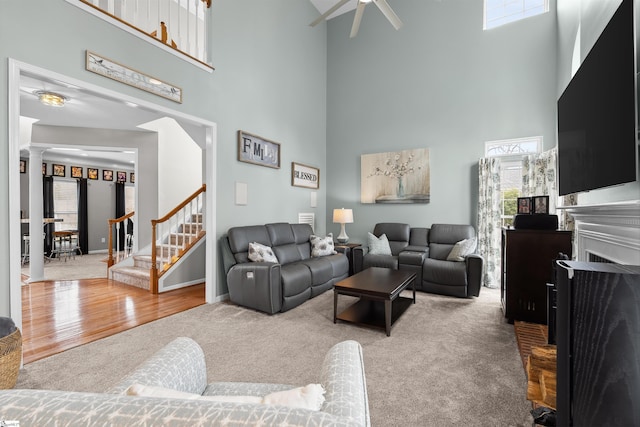 103 Hornbuckle Dr, Easley, SC 29642 - carpeted living area featuring ceiling fan, wood finished floors, stairs, ornate columns, and a fireplace