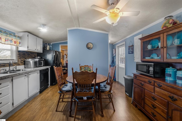 dining room featuring ornamental molding, light wood-type flooring, ceiling fan, and a textured ceiling