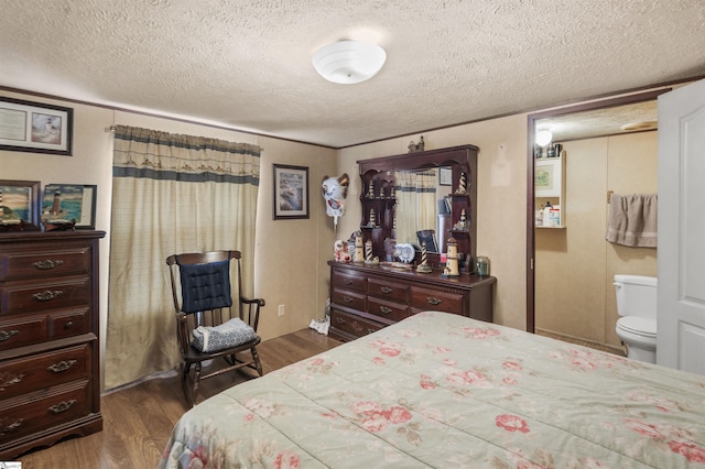 bedroom featuring a textured ceiling and dark wood-type flooring