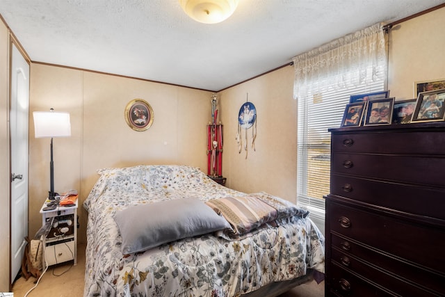 bedroom with crown molding, a textured ceiling, and carpet flooring