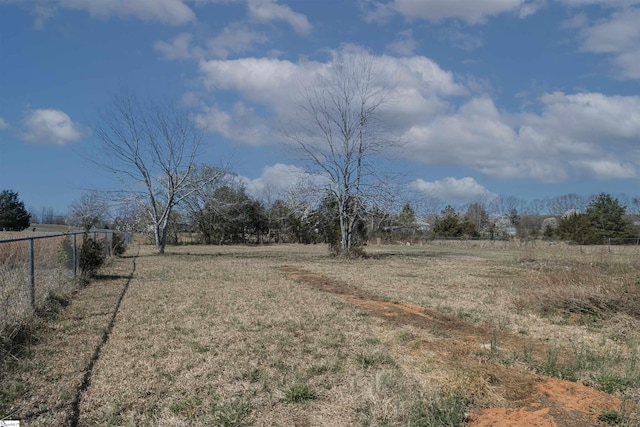 view of yard featuring a rural view and fence