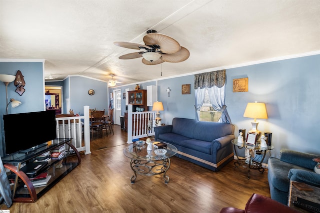 living room with vaulted ceiling, ceiling fan, ornamental molding, and wood finished floors