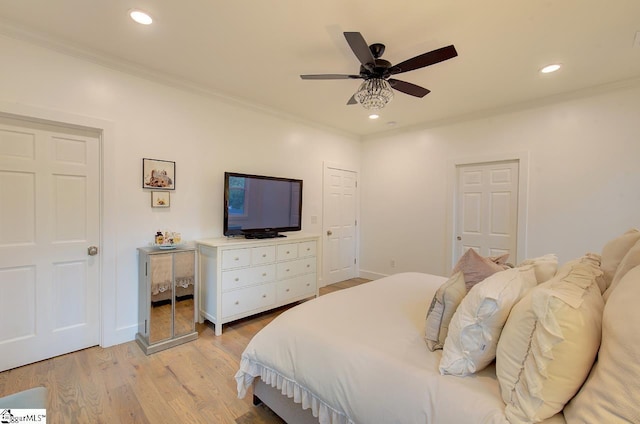 bedroom with recessed lighting, crown molding, and light wood-style flooring