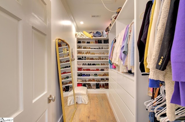 walk in closet with wood finished floors and visible vents