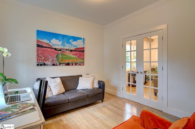 living room featuring french doors, crown molding, light wood-style flooring, and baseboards