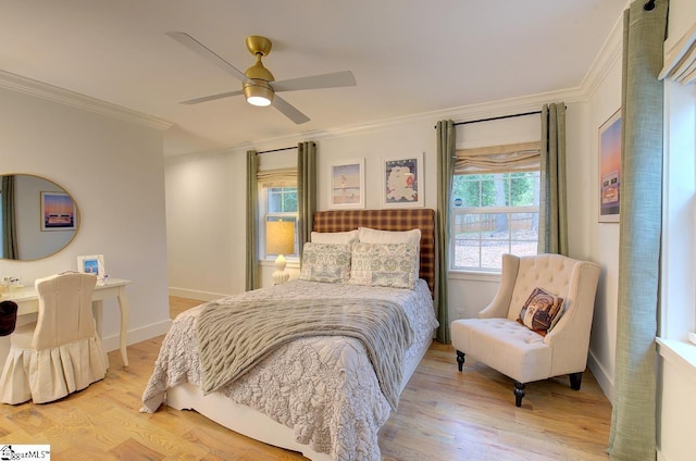 bedroom featuring ceiling fan, ornamental molding, wood finished floors, and baseboards