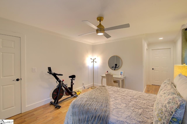 bedroom with ornamental molding, light wood finished floors, a ceiling fan, and baseboards