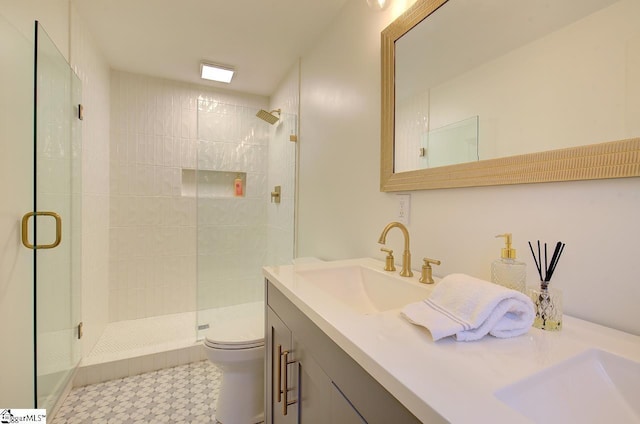 full bathroom with a shower stall, toilet, and vanity