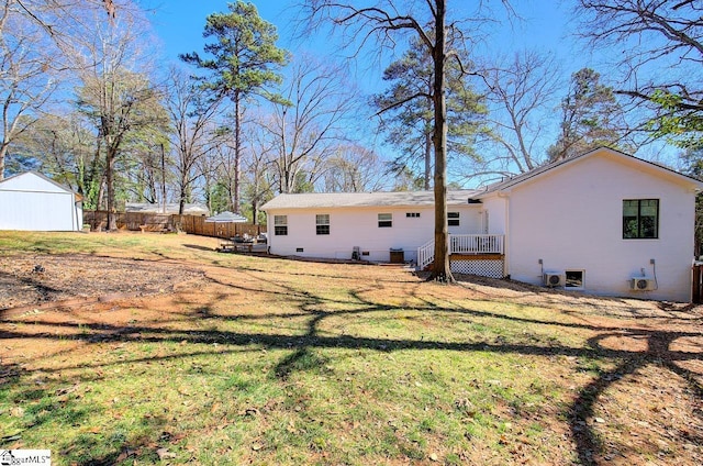 rear view of property with fence and a yard