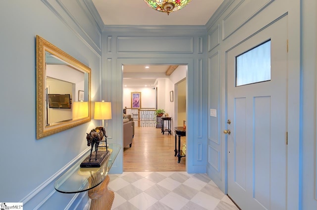 entrance foyer with a decorative wall and light floors