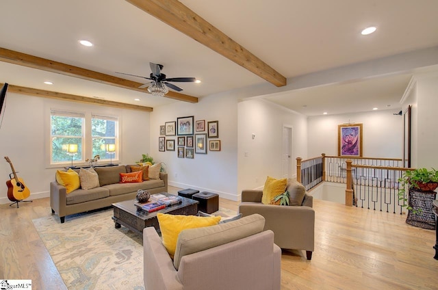 living room with beam ceiling, recessed lighting, light wood-style flooring, and baseboards