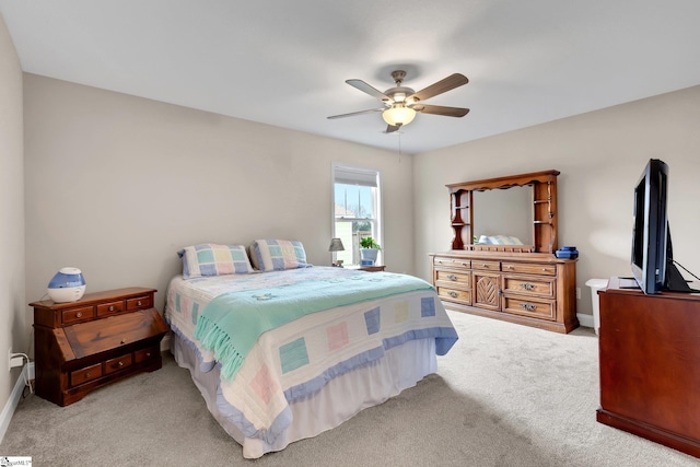 carpeted bedroom featuring a ceiling fan and baseboards