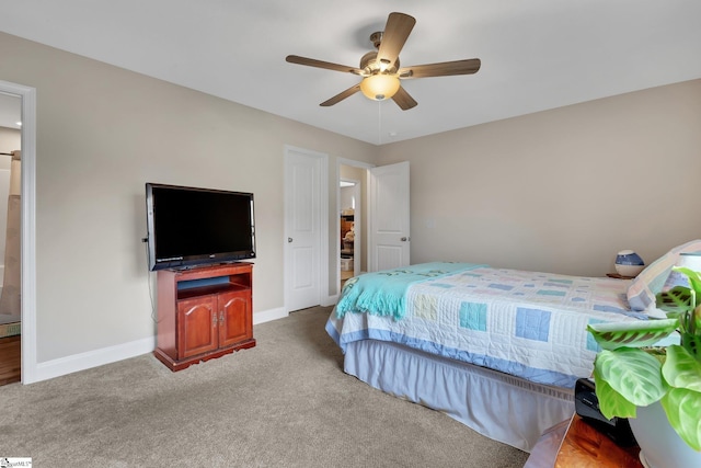 carpeted bedroom with a ceiling fan and baseboards