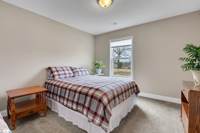 carpeted bedroom with visible vents and baseboards