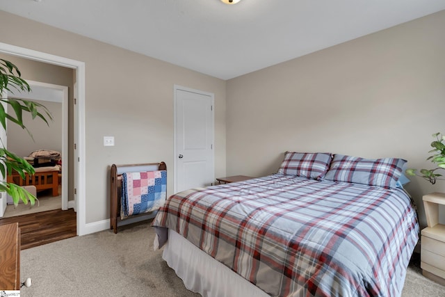 carpeted bedroom with baseboards