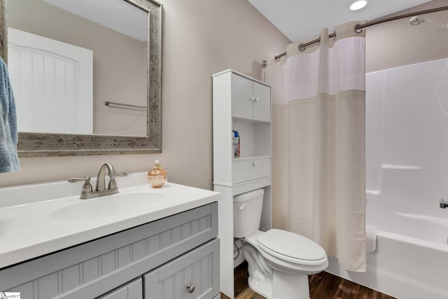 full bathroom with toilet, shower / bath combo with shower curtain, wood finished floors, and vanity