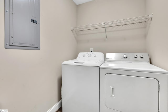 laundry area with laundry area, independent washer and dryer, electric panel, and baseboards