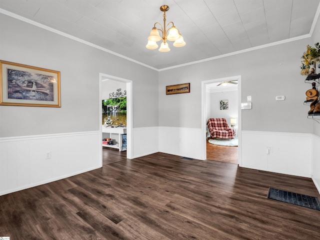 unfurnished dining area with crown molding, a chandelier, wood finished floors, and wainscoting