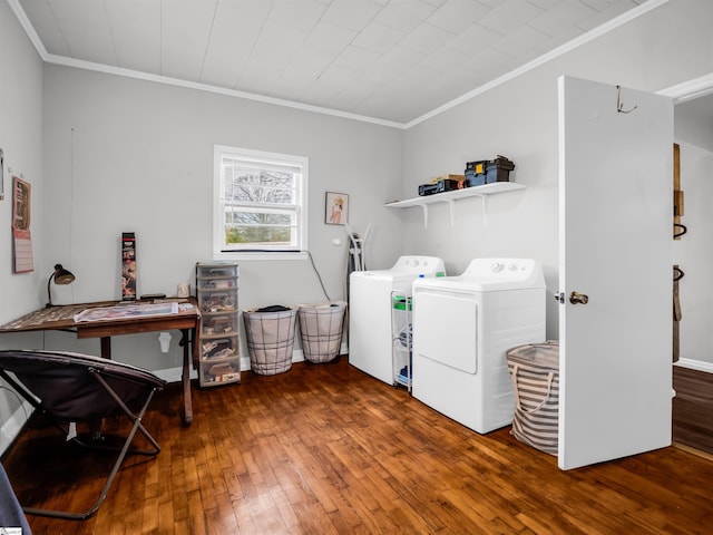 clothes washing area with laundry area, hardwood / wood-style floors, washing machine and dryer, and crown molding