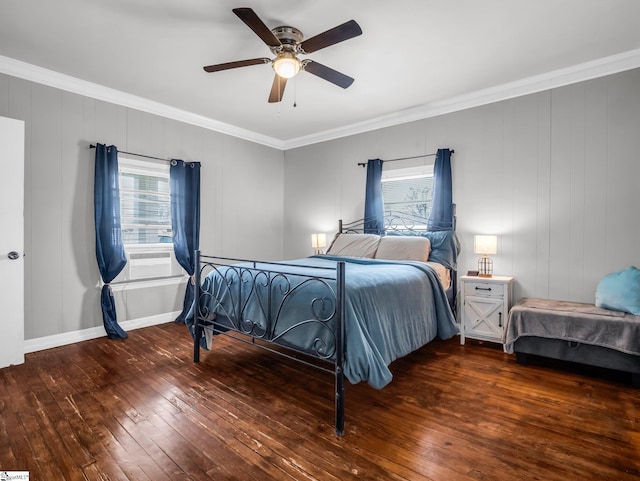 bedroom with a ceiling fan, multiple windows, ornamental molding, and hardwood / wood-style floors