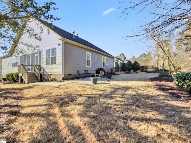 back of house featuring a lawn, a patio area, fence, and crawl space