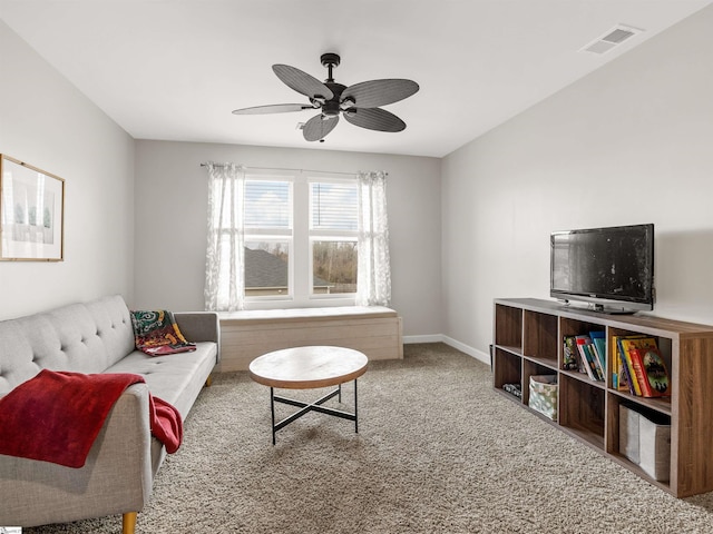 carpeted living room with a ceiling fan, visible vents, and baseboards