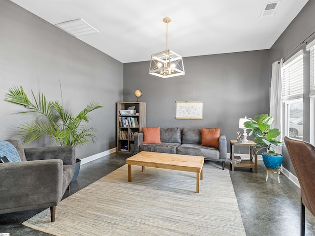 living area featuring concrete flooring, visible vents, and baseboards