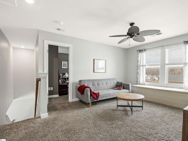 carpeted living room with baseboards, visible vents, and ceiling fan
