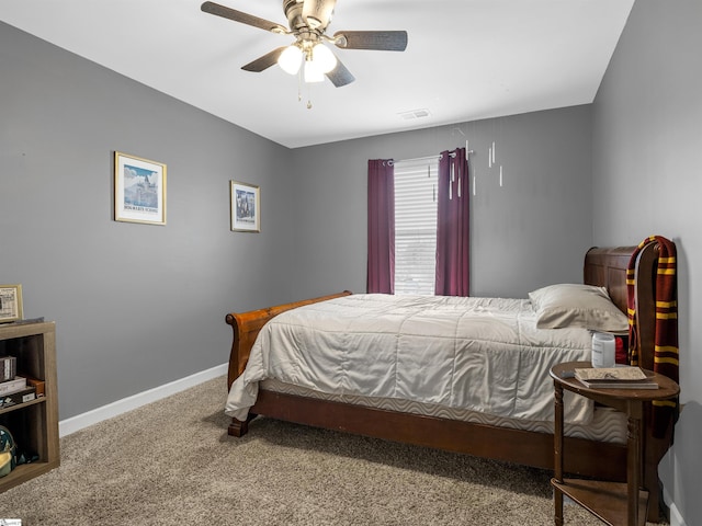 carpeted bedroom with a ceiling fan, visible vents, and baseboards
