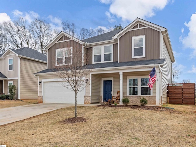 craftsman-style house with concrete driveway, brick siding, board and batten siding, and fence